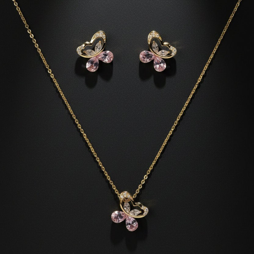 SVORA gold tone butterfly necklace and earrings set with pink crystals and cubic zirconia accents.