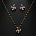 SVORA gold tone butterfly necklace and earrings set with pink crystals and cubic zirconia accents.