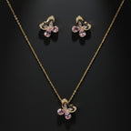 SVORA gold tone butterfly necklace and earrings set with pink crystals and cubic zirconia accents.
