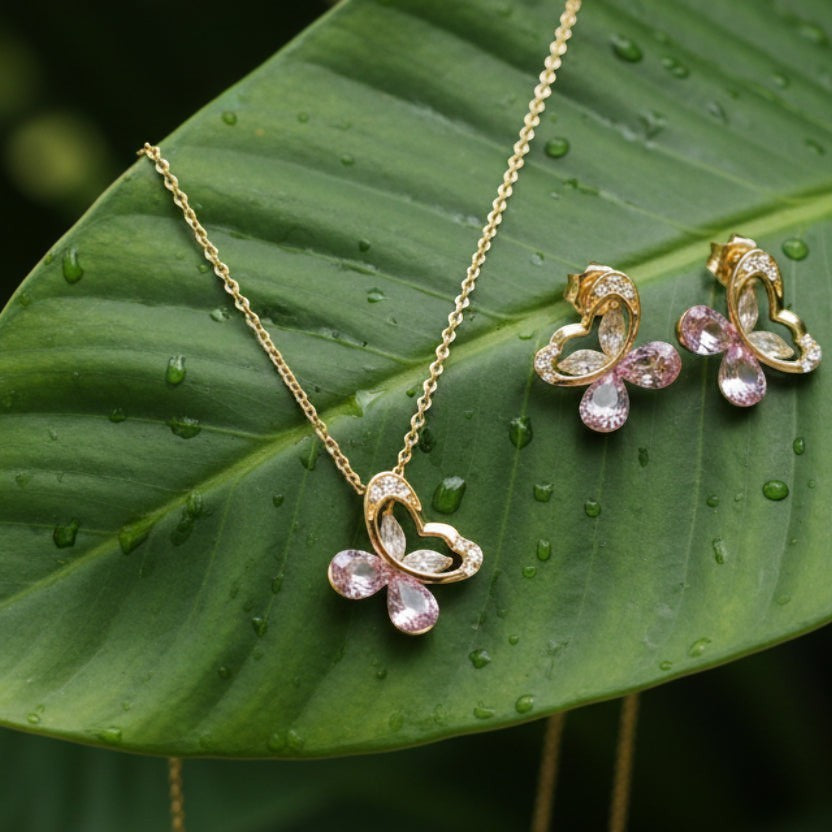 SVORA gold tone necklace and earrings set with butterfly pendants, pavé cubic zirconia and pink crystal teardrops.
