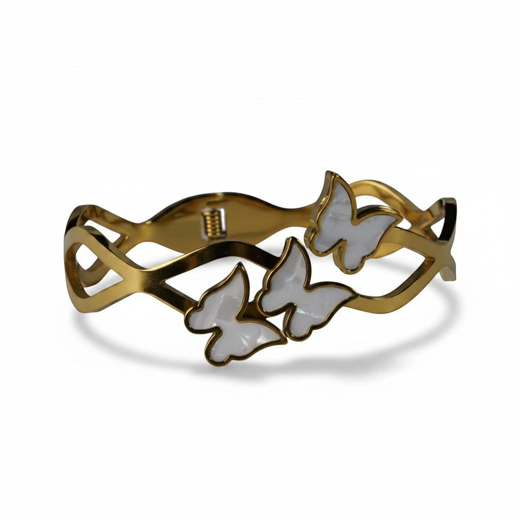 SVORA gold-plated stainless steel bracelet with three mother-of-pearl butterflies and wave-edged band.