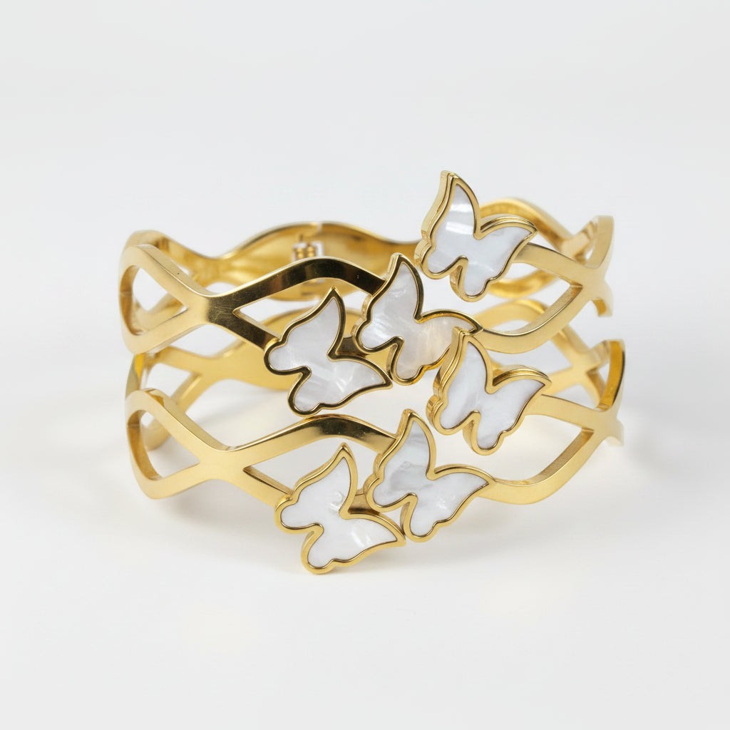 SVORA gold-plated stainless steel bracelet with mother-of-pearl butterflies and wave-edged band.