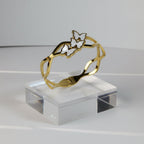 SVORA gold-plated stainless steel bracelet with three mother-of-pearl butterflies, wave-edged band.