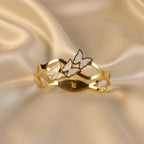 SVORA gold-plated stainless steel bracelet with three mother-of-pearl butterflies and wave-edged band.