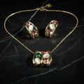 SVORA gold tone necklace and earrings set with pink, green, and cream cabochon stones in a caged design.