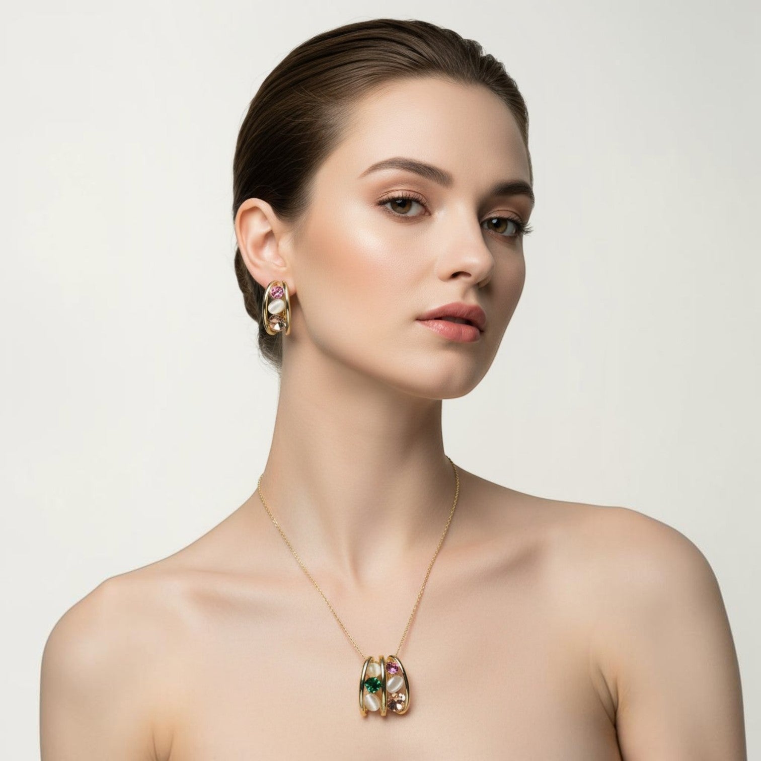 SVORA gold tone necklace and earrings set with pink, green, and cream cabochon stones in a caged design.
