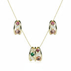 SVORA gold tone necklace and earrings set with pink, green, and cream cabochon stones in a cage design.
