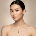 SVORA oval champagne crystal and gold tone necklace and earrings set on a model.