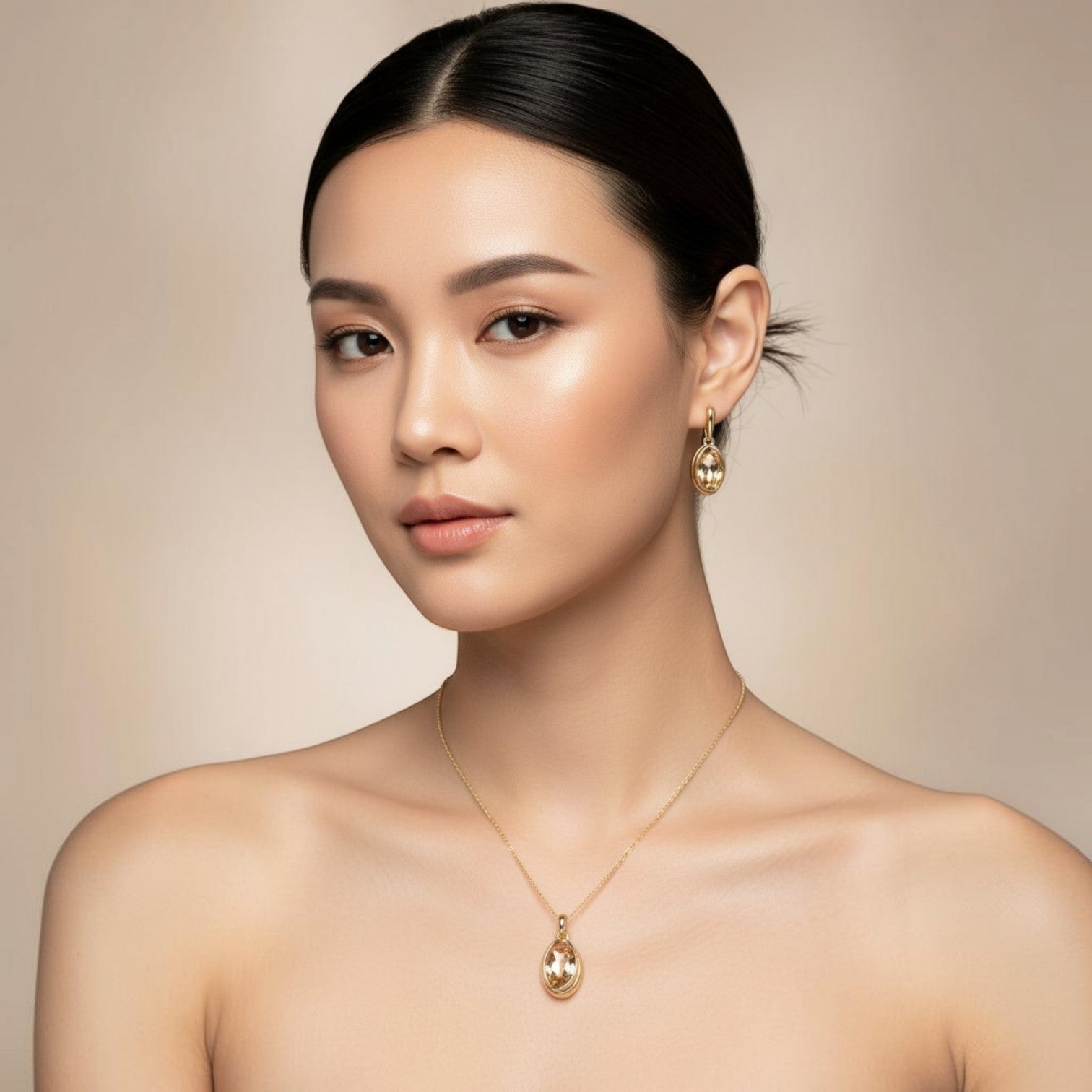 SVORA oval champagne crystal and gold tone necklace and earrings set on a model.