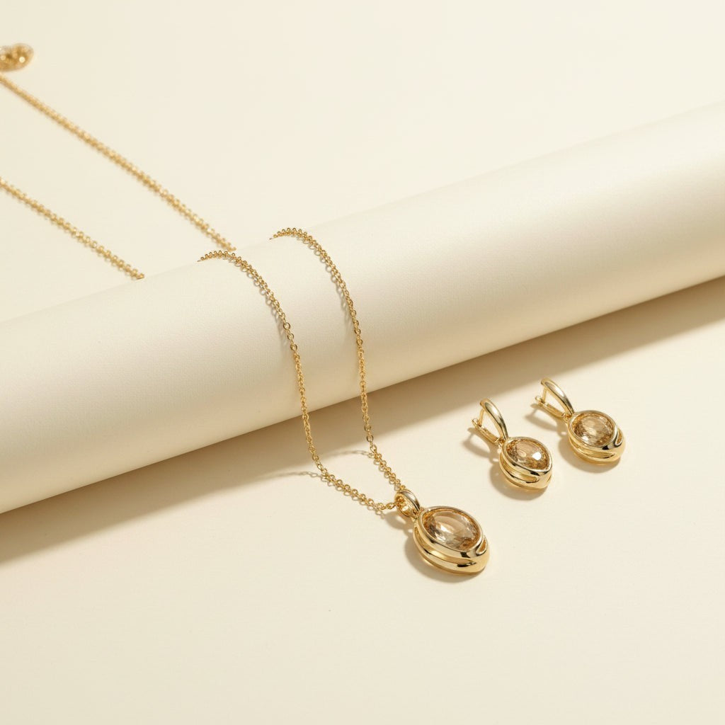 SVORA oval champagne crystal necklace and earrings set with gold-tone stainless steel.