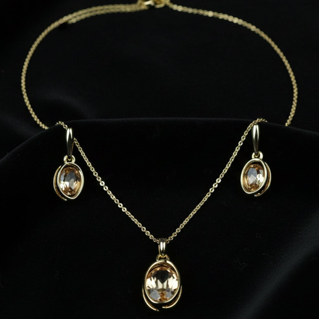 SVORA oval champagne crystal necklace and earrings set with gold-tone plating and polished finish.