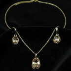 SVORA oval champagne crystal necklace and earrings set with gold-tone plating and polished finish.