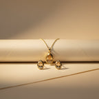 SVORA champagne pear-cut crystal necklace and matching earrings set in polished gold.