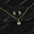 SVORA gold-tone stainless steel necklace and earrings set with champagne pear-cut crystals.