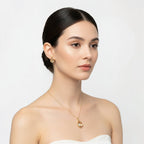 SVORA champagne pear-cut crystal necklace and earrings set in polished gold tone stainless steel.