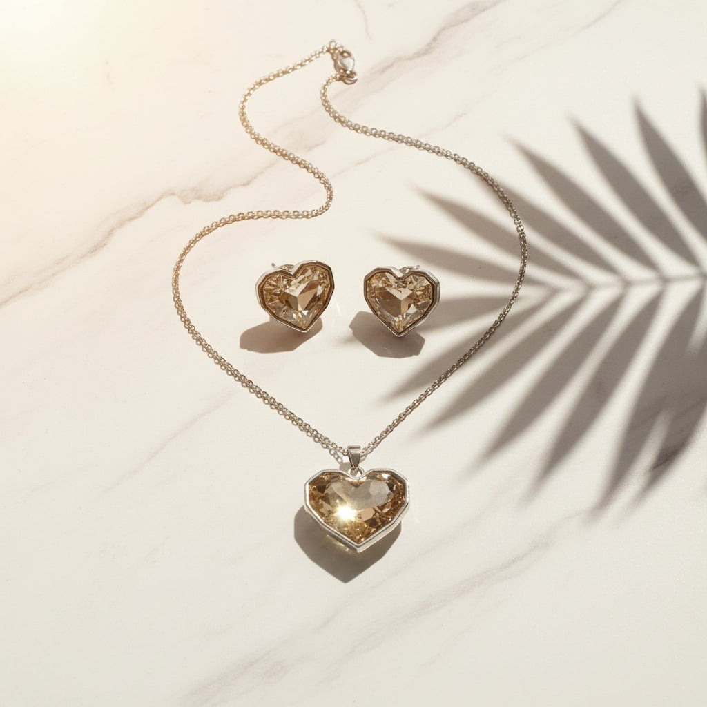 SVORA champagne crystal heart necklace and earrings set with silver bezels and chain. High polish finish.