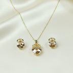 SVORA champagne nugget necklace and earrings set with faceted crystals and cubic zirconia accents, 18K gold tone.