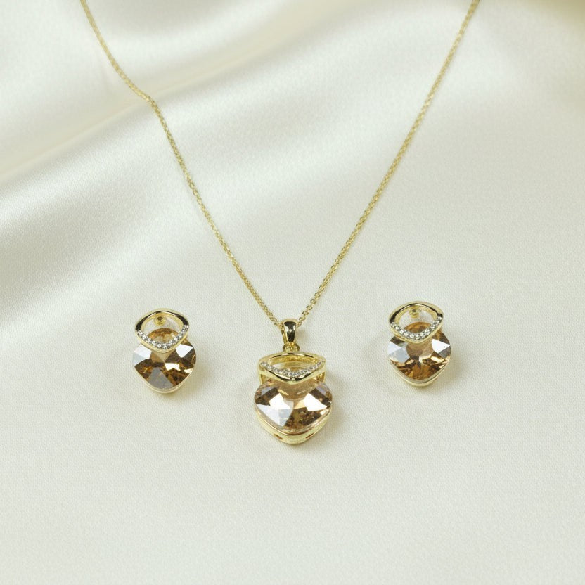 SVORA champagne nugget necklace and earrings set with faceted crystals and cubic zirconia accents, 18K gold tone.