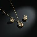SVORA champagne crystal pendant necklace and matching earrings with pavé detail, 18K gold tone.