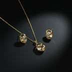 SVORA champagne crystal pendant necklace and matching earrings with pavé detail, 18K gold tone.
