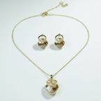 SVORA champagne crystal pendant necklace and matching earrings set with pavé detail and gold-tone chain.