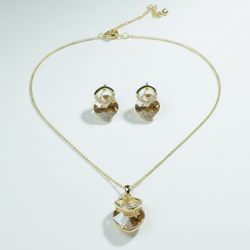 SVORA champagne crystal pendant necklace and matching earrings set with pavé detail and gold-tone chain.