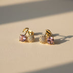 SVORA gold tone stud earrings with pink crystal and pavé cherry design, featuring a gold leaf accent.