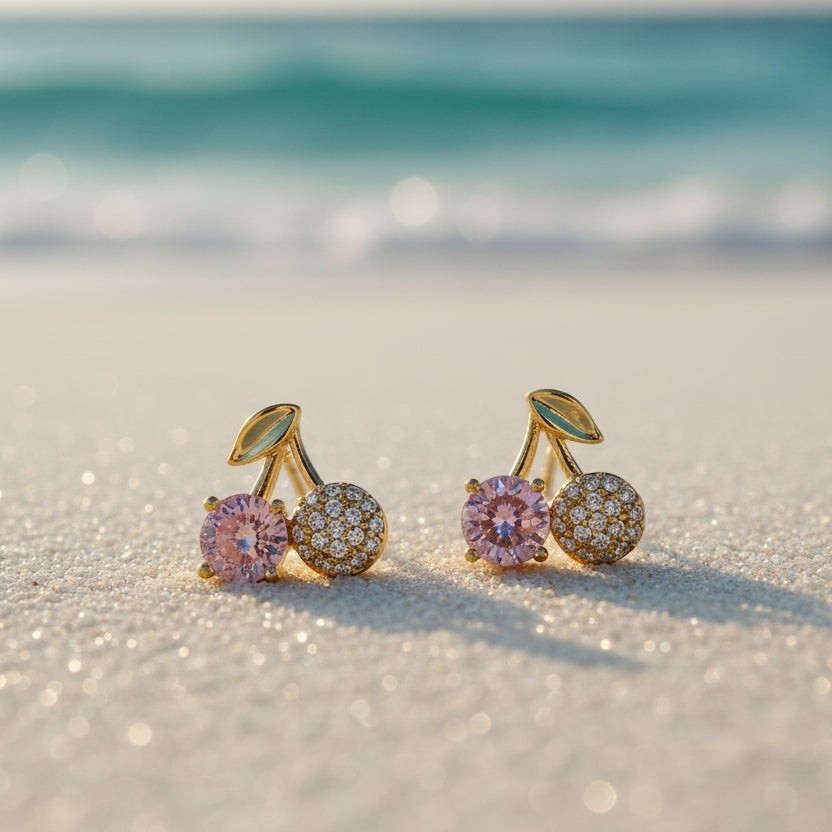 SVORA gold cherry stud earrings with pink and clear cubic zirconia stones and a gold leaf detail.