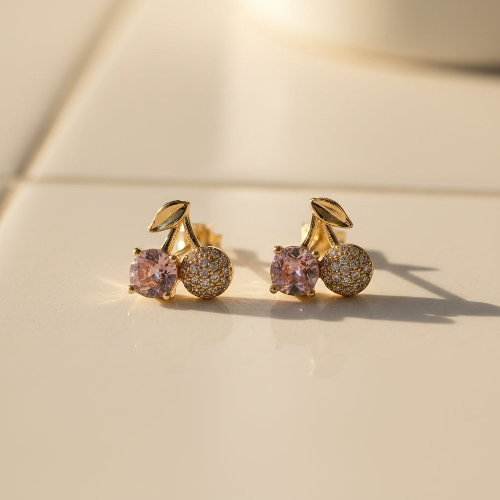 SVORA gold tone stud earrings with pink crystal and pavé cherry design, featuring a gold leaf accent.
