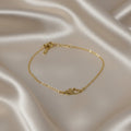 SVORA gold plated stainless steel bracelet with two connected hearts, one solid and one open. Adjustable.