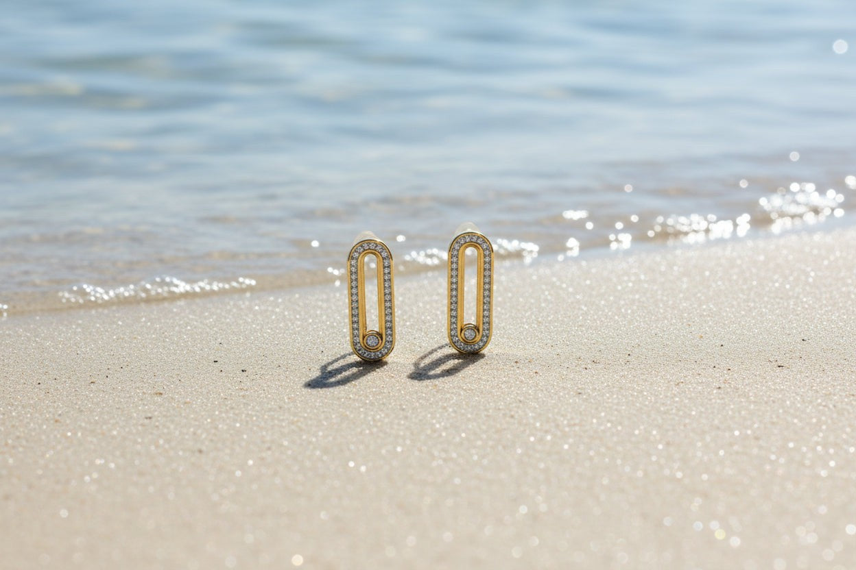 SVORA gold tone stainless steel dangle earrings with pavé cubic zirconia bars and a moving stone detail.