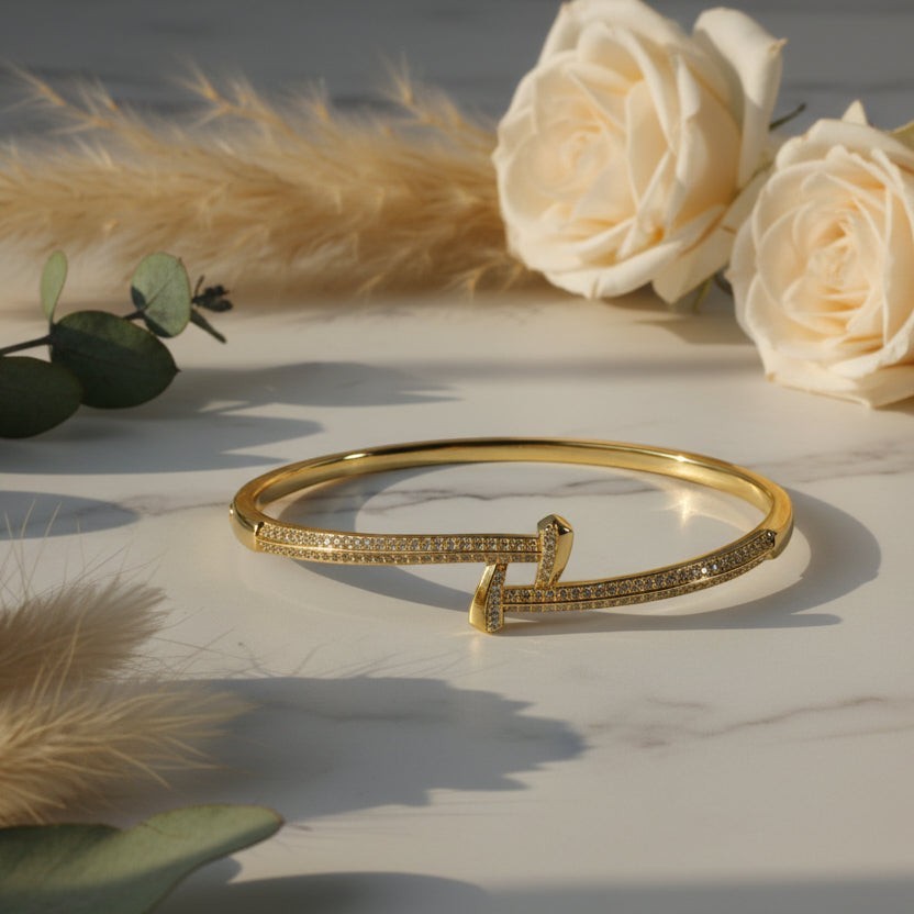 SVORA gold-plated stainless steel crossover bangle bracelet with CZ stones. Waterproof and anti-tarnish.