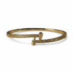 SVORA gold plated stainless steel crossover bangle bracelet with cubic zirconia stones.