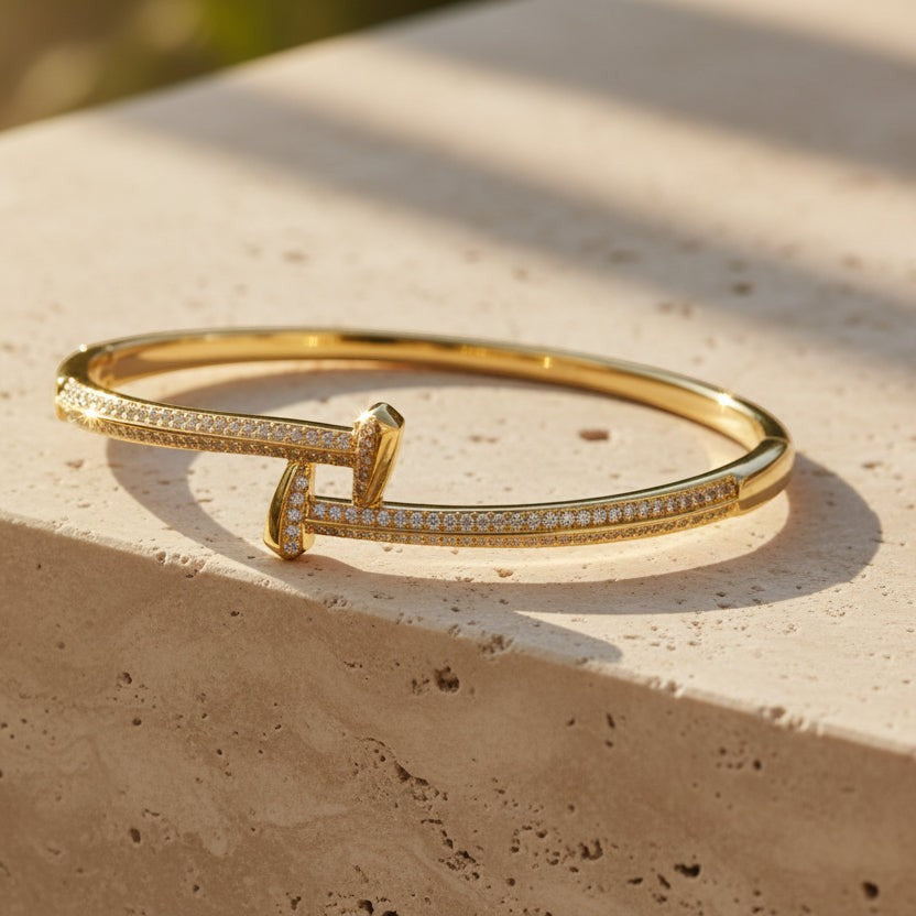 SVORA gold plated stainless steel crossover bangle bracelet with CZ stones. Waterproof and anti-tarnish.