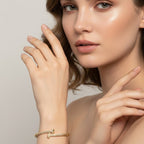SVORA gold plated stainless steel crossover bangle bracelet with CZ stones