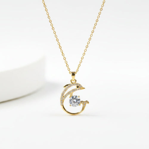SVORA gold-plated stainless steel necklace with a pavé crystal dolphin pendant holding a large white CZ.