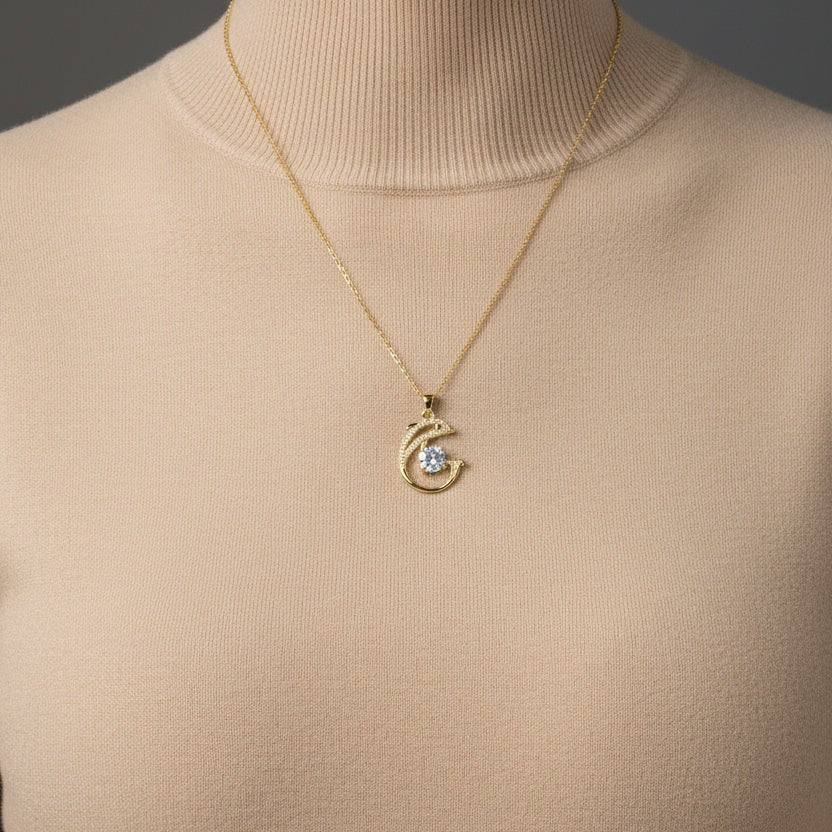 SVORA gold-plated stainless steel necklace with a pavé dolphin pendant and a large white CZ.