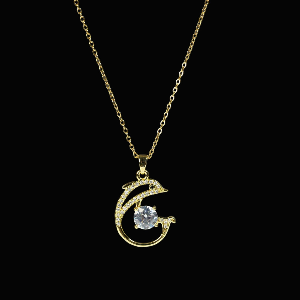 SVORA gold-tone stainless steel necklace with a pavé crystal dolphin pendant holding a large clear CZ.