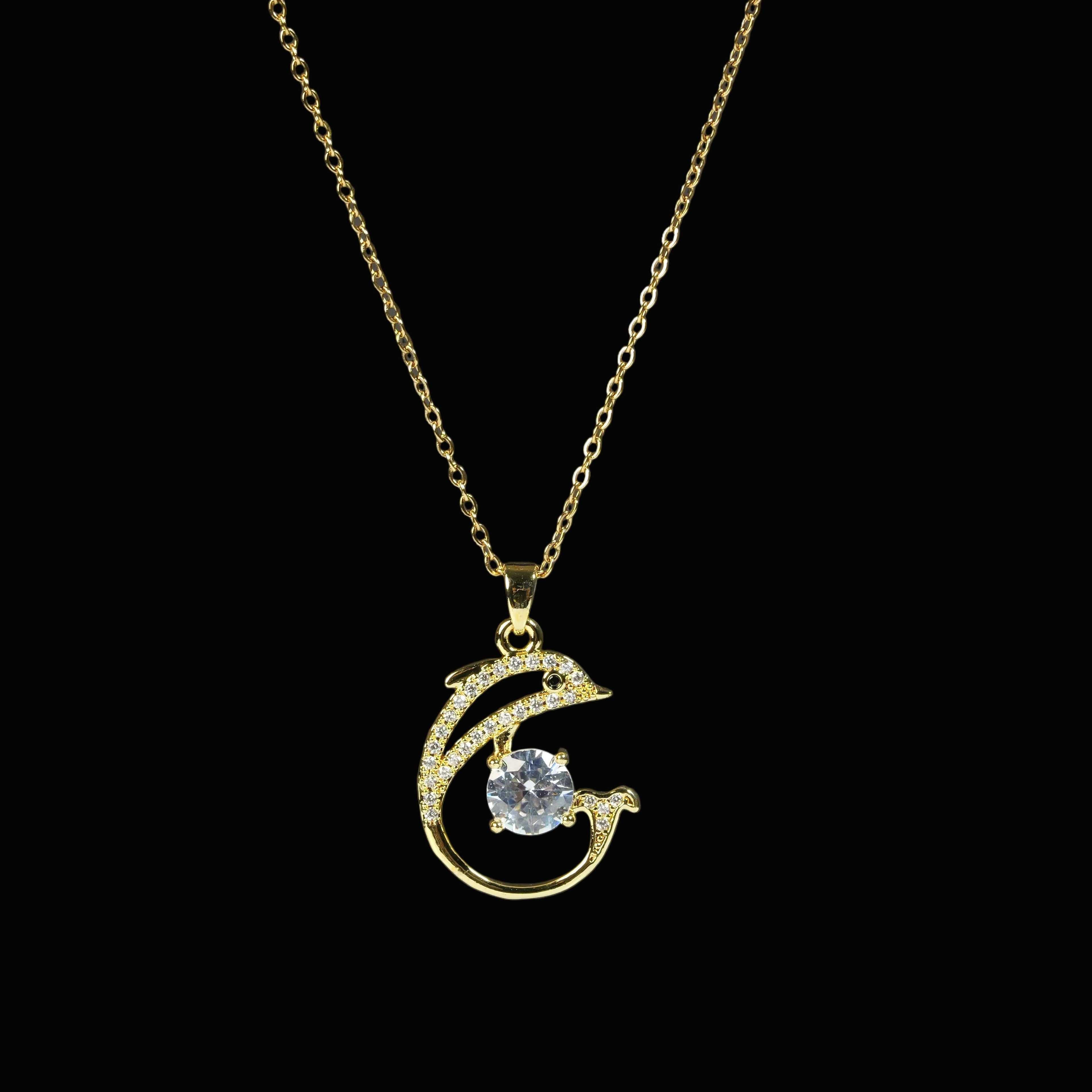 SVORA gold-tone stainless steel necklace with a pavé crystal dolphin pendant holding a large clear CZ.