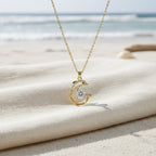 SVORA gold-plated stainless steel dolphin pendant necklace with pavé CZ and large central white CZ. Waterproof.
