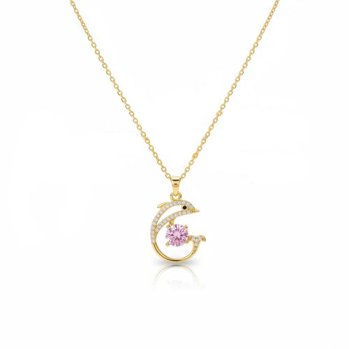 SVORA gold plated stainless steel necklace with a pavé dolphin pendant holding a pink cubic zirconia stone.