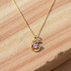 SVORA gold plated stainless steel necklace featuring a pavé dolphin pendant with a large pink CZ stone.