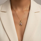 SVORA gold plated dolphin pendant necklace with pink cubic zirconia and pavé details.