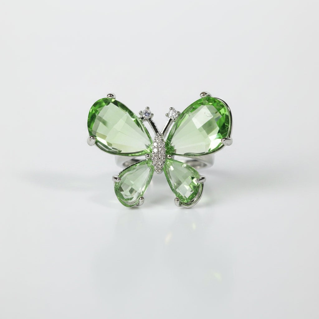 SVORA Ethereal Emerald Butterfly Ring with green pear-cut wings and pavé body on a silver band.