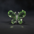 SVORA Ethereal Emerald Butterfly Ring with pear-cut green wings and pavé body on a silver band.