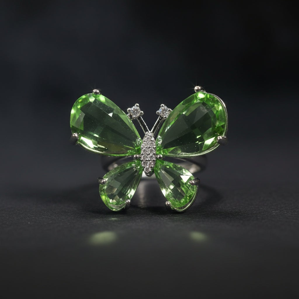 SVORA Ethereal Emerald Butterfly Ring with pear-cut green wings and pavé body on a silver band.