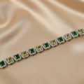 SVORA Emerald Halo Tennis Bracelet with alternating emerald green and olive green princess-cut CZ stones, surrounded by small white CZs, set in silver.