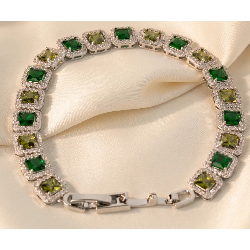 SVORA Emerald Halo Tennis Bracelet with alternating green and olive princess-cut CZ stones, silver-plated stainless steel.