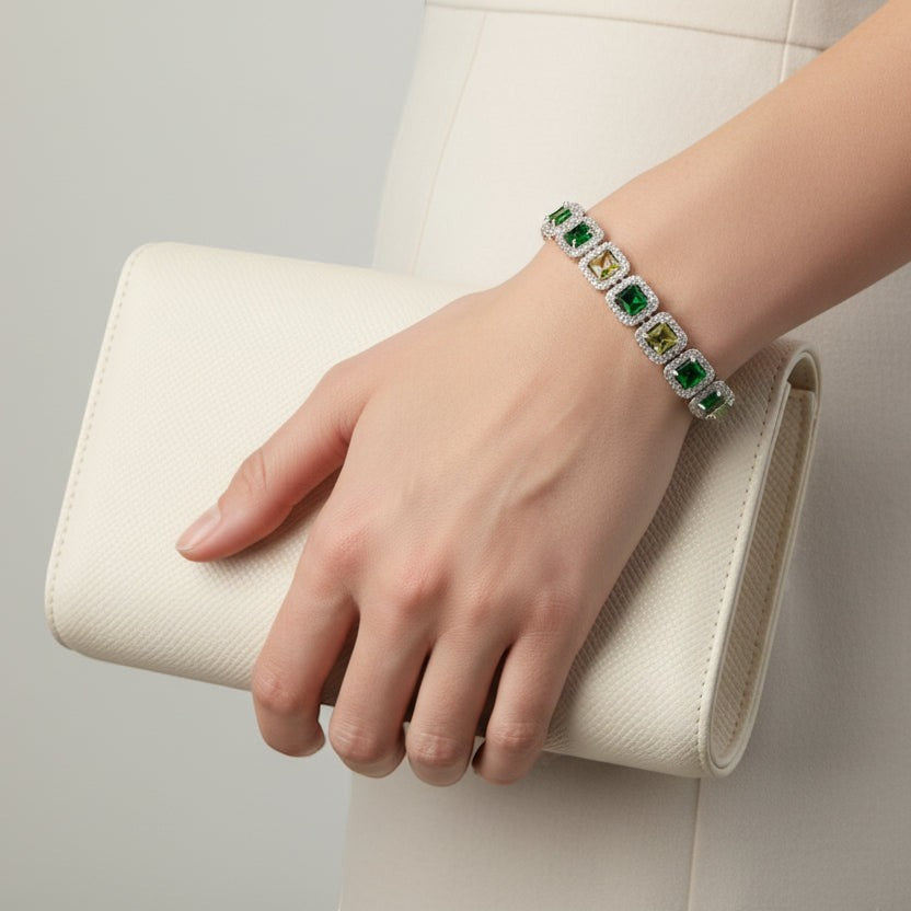 SVORA Emerald Halo Tennis Bracelet with princess-cut emerald, olive, and clear CZ stones set in silver.