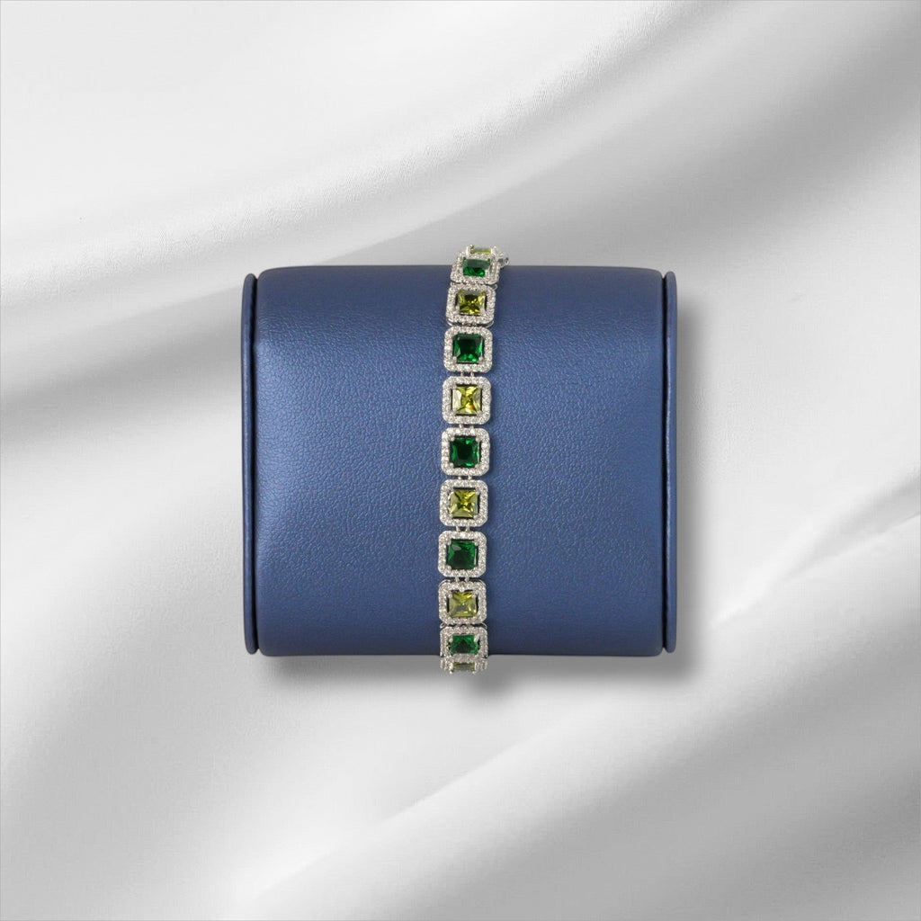 SVORA Emerald Halo Tennis Bracelet with princess-cut emerald, olive, and clear CZ stones set in silver.
